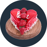 Red heart-shaped cake topped with strawberries
