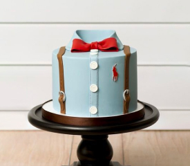 Cake designed with blue icing and toy cars, ideal for celebrating a boy's special day.