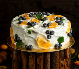  A close-up photo of a delicious fruit cake with colorful fruits on top, making it look irresistibly cravy.