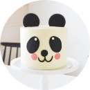 A panda cake with a cute panda face decoration on top