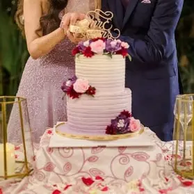 Newlyweds slicing into a wedding cake together
